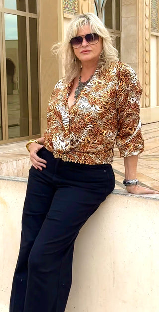 Six-foot-two model wearing Tiger Twist Crop Top front view, twist detail and deep V neckline