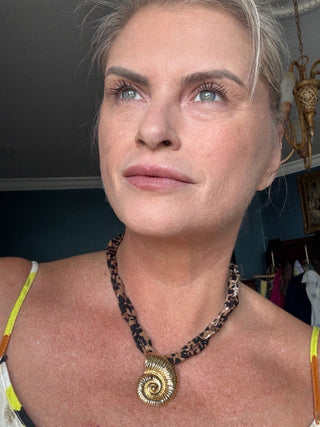 sea shell on leopard material neckalce. adjustable tie in the back for desired lengths