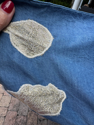 Close up of embroidered gold applique