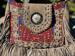 Leather Satchel Bag Crossbody! The stunning tan base including; red, purple, gold and intricate embroidery, paired with trendy fringe, make this bag a must-have. Use the wider shoulder strap to wear as a purse, or the adjustable leather strap for a casual crossbody look. Both are removable for versatility. Crafted from durable leather, it's the perfect statement piece for any outfit. Keep your essentials close and ride in style!  SIZE: 12"X12"X 2"