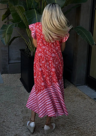 The Darla Dress, a stunning piece that combines timeless elegance with modern versatility. Made from pre-shrunk cotton, this dress features a classic red paisley pattern and delicate flutter sleeves, making it a must-have for any fashion-forward woman. Whether you're dressing up for a formal occasion or keeping it casual, The Darla Dress is designed to make you feel sophisticated and charming.