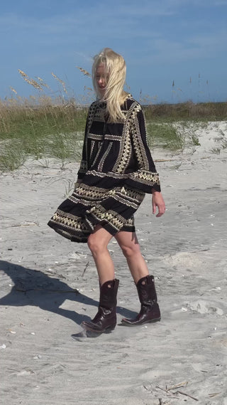 Daphne mini dress styled with boots on tall model at beach